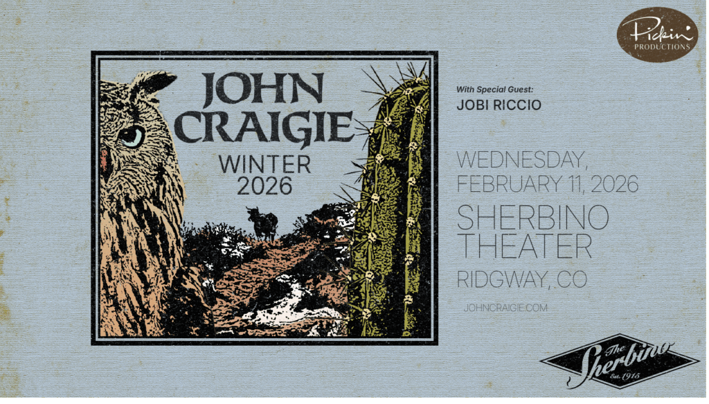 Promotional poster for musician John Craigie’s Winter 2026 tour. The artwork shows a desert landscape with an owl on the left, a tall cactus on the right, and a silhouette of a cow in the distance under a blue-gray sky. The text reads: “John Craigie Winter 2026 — With special guest: Jobi Riccio. Wednesday, February 11, 2026, Sherbino Theater, Ridgway, CO.” The logos for Pickin’ Productions and The Sherbino appear on the right side and bottom of the image. The design has a rustic, hand-illustrated style with muted desert colors and a textured background.